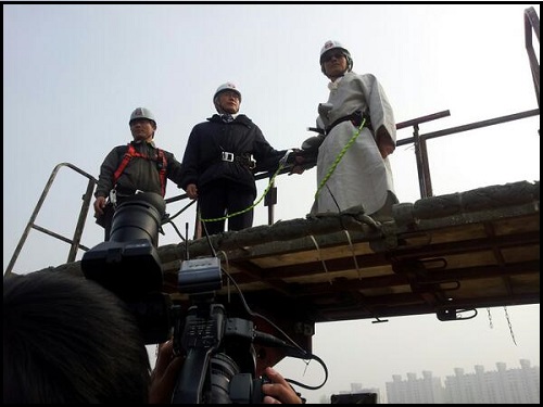 문재인 전 민주통합당 대선후보(가운데)가 7일 쌍용차 평택 철탑 농성장을 찾아, 고공농성 중인 노동자들을 만나기 위해 고가사다리차를 이용해 철탑에 오르고 있다. ⓒ 민주통합당 은수미 의원 트위터