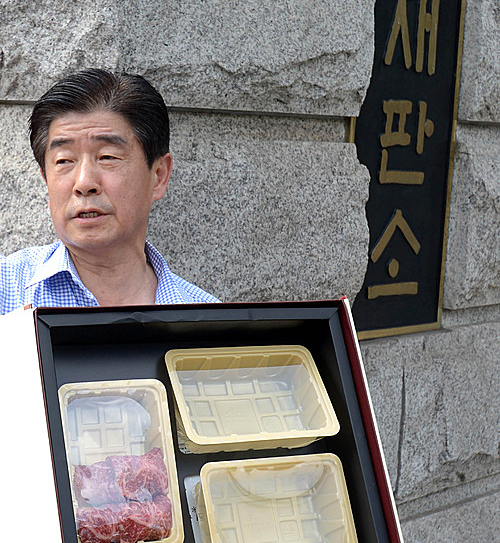 헌법재판소가 '김영란법'으로 불리는 '부정청탁 및 금품 등 수수의 금지에 관한 법률(부정청탁금지법)' 에 대한 헌법소원심판 사건에서 합헌 결정한 가운데 28일 오후 서울 종로구 재동 헌법재판소 앞에서 한국농축산연합회 황태수 사무총장이 한우 5만원 세트 실물을 들어 보이고 있다. <사진제공=뉴시스>