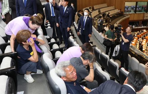 ▲ 이태원참사 유가족들이 30일 오후 서울 여의도 국회에서 열린 제407회국회(임시회) 제7차 본회의에서 10.29이태원참사 피해자 권리보장과 진상규명 및 재발방지를 위한 특별법안에 대한 신속처리안건 지정동의의 건이 가결되자 손으로 손으로 얼굴을 감싸고 있다. <사진제공=뉴시스>
